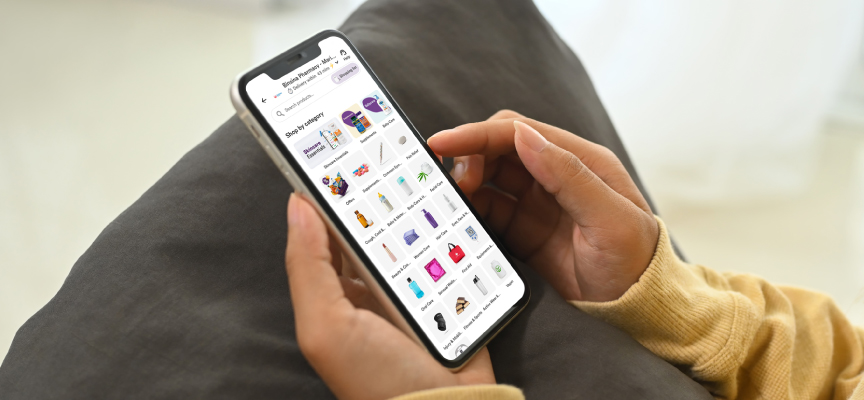 Customer browsing the online pharmacy app on a smartphone to choose health essentials and prescription medicines.