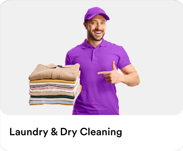 Smiling dry cleaning courier holding a stack of neatly folded laundry clothes for home pickup and delivery services.