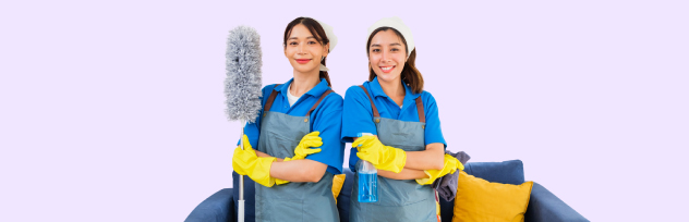 Two professional cleaning maids holding dusters and spray bottles representing top-rated home cleaning services in Abu Dhabi.