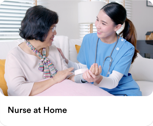 Home care nurse in blue scrubs checking an elderly patient's blood pressure to illustrate professional nurse at home care services.