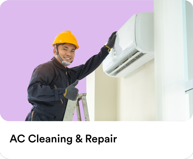 Certified technician wearing a safety hard hat on a ladder checking an air conditioning split unit for residential AC cleaning and repair services.